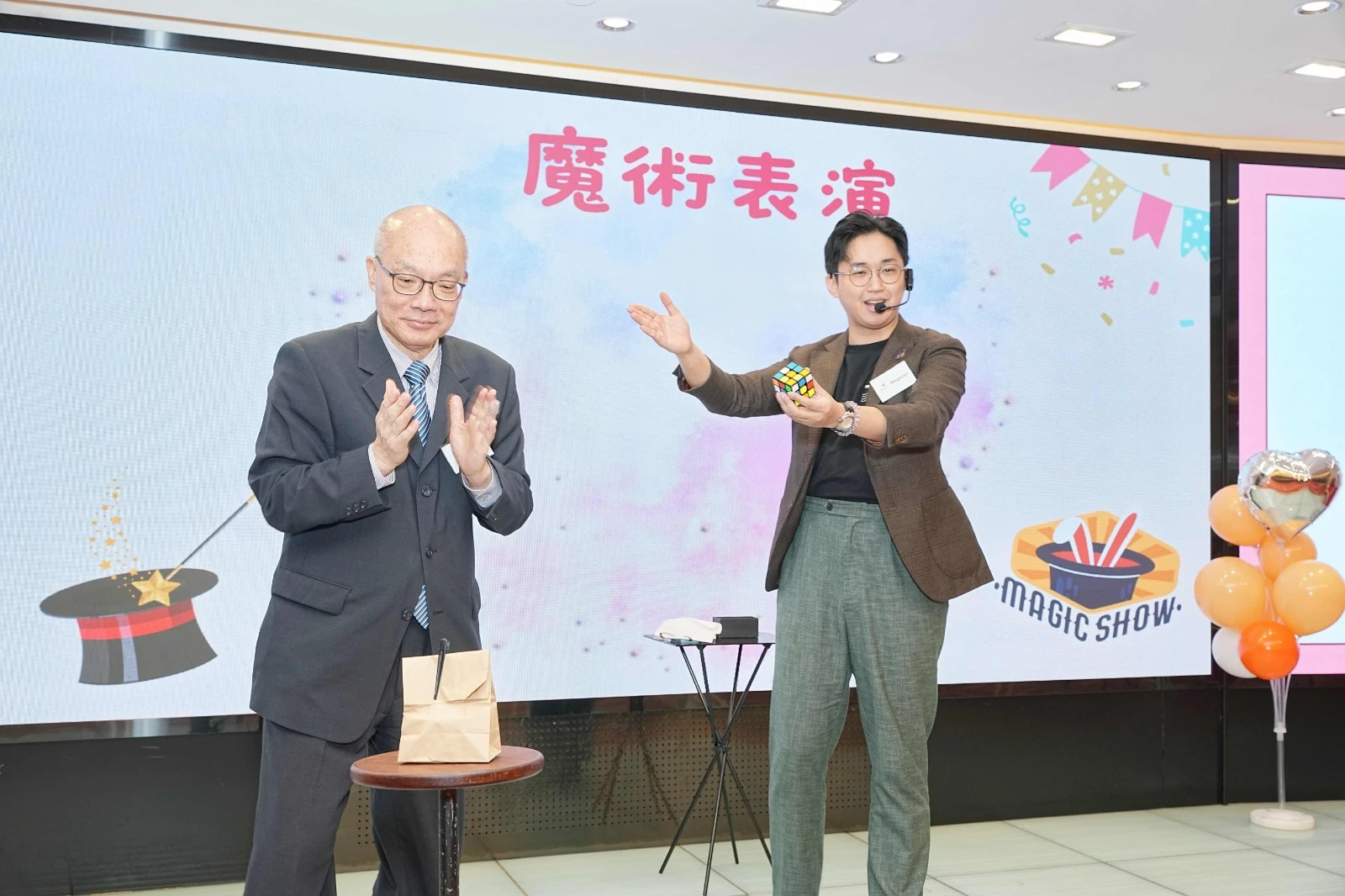 Employee on stage being the star of the magic show