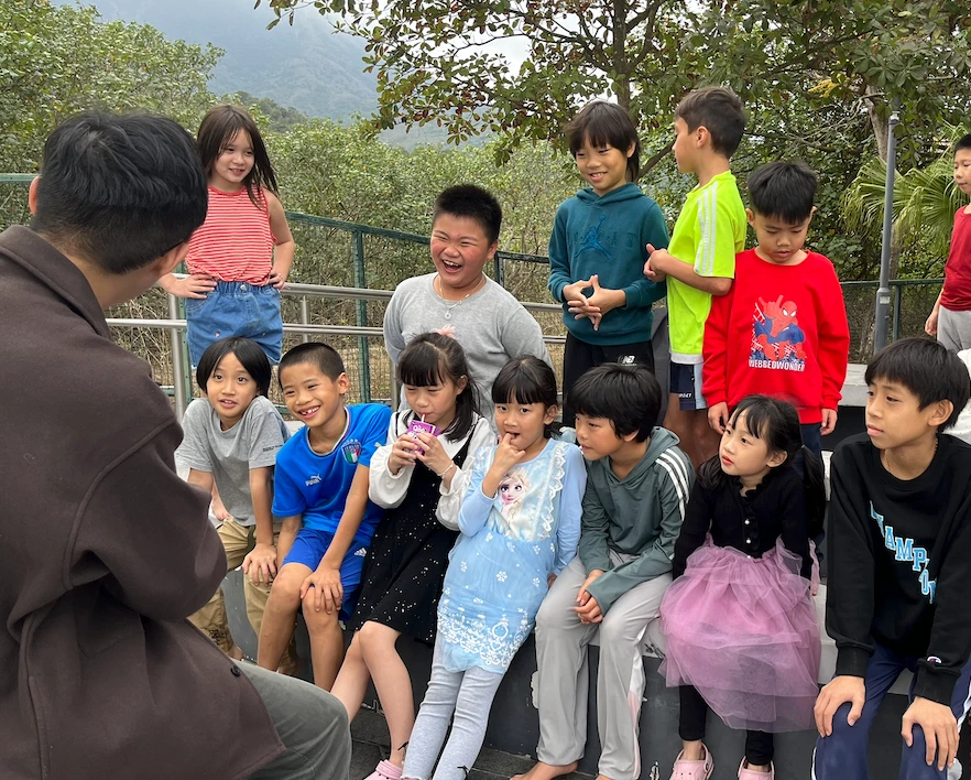 Group of 3-5 year old children laughing hysterically at a magic show